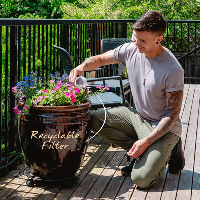 A man opening his recyclable Santevia MINA Alkaline Pitcher filter and composting the minerals#colour_white